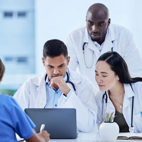 Picture of medical professionals looking at a computer.