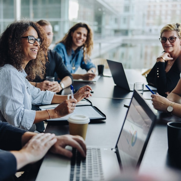 Picture of people in a meeting with laptops