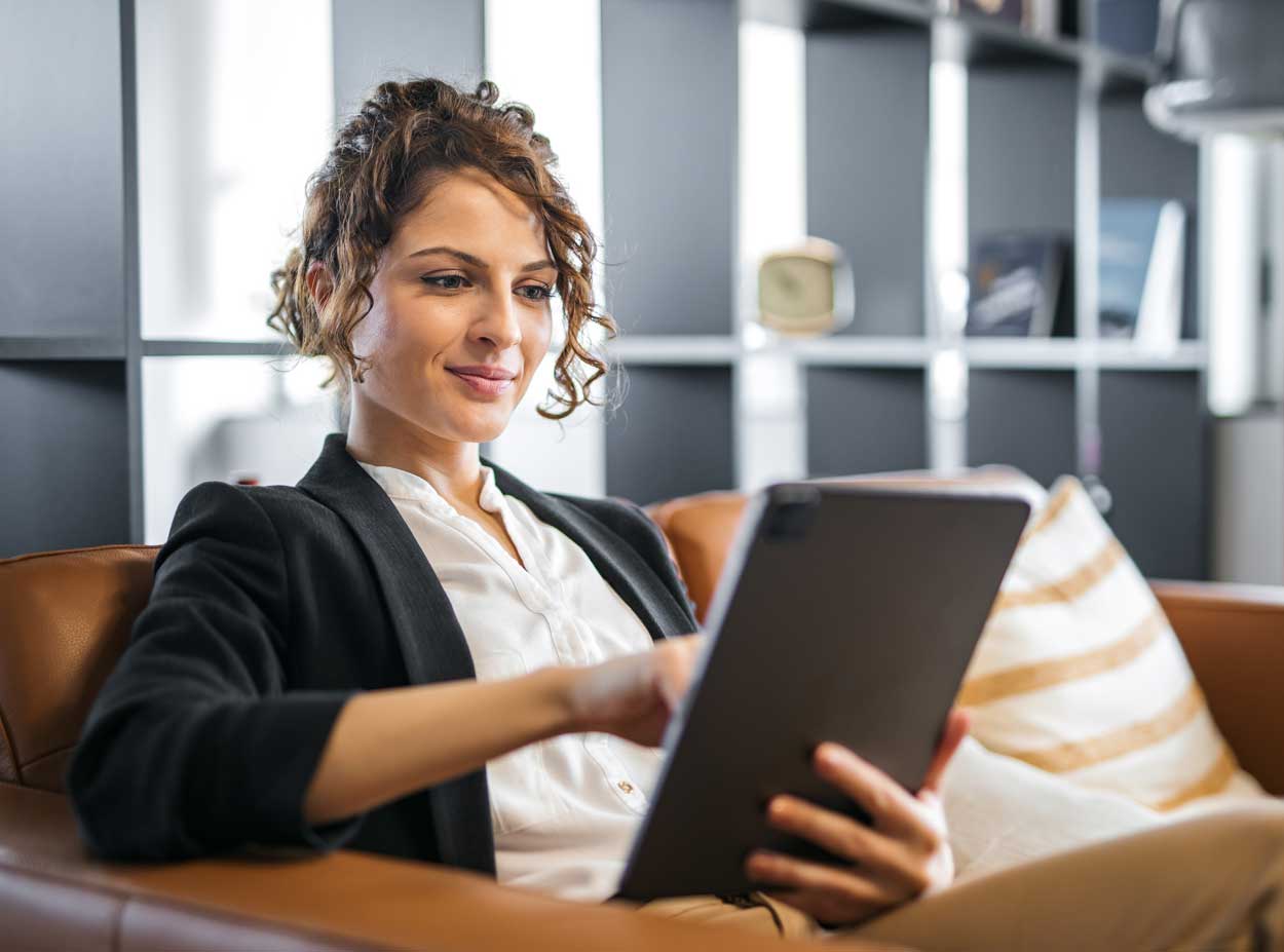 Woman with ipad smiling about Managed IT