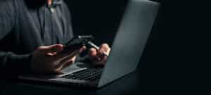 Businessman is working on Smartphone and Laptop.