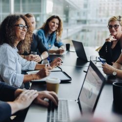 Picture of people in a meeting with laptops talking about Managed IT Services.